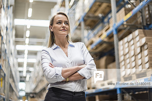 Portrait of confident woman in factory storehouse