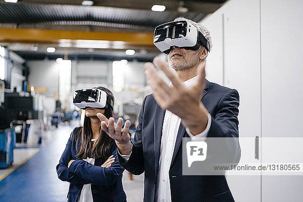 Businessman an woman in high tech enterprise  using VR glasses