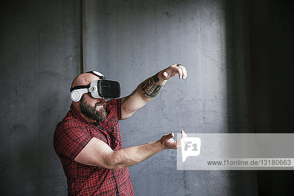 Bearded man wearing VR glasses