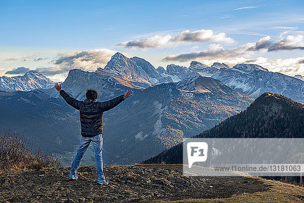 Italy South Tyrol Seiser Alm Hiker in front of Seceda and Sass Rigais at sunrise
