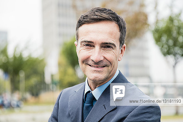 Portrait of smiling businessman in the city