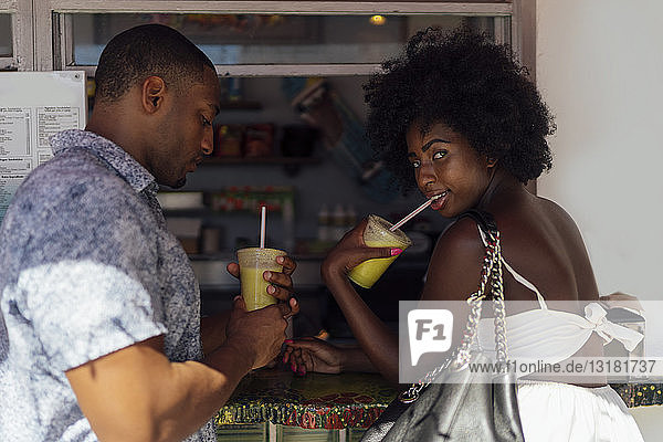 Young couple having a drink at a kiosk