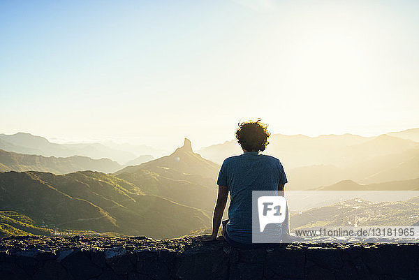 Spain  Canary Islands  Gran Canaria  back view of man watching mountain landscape