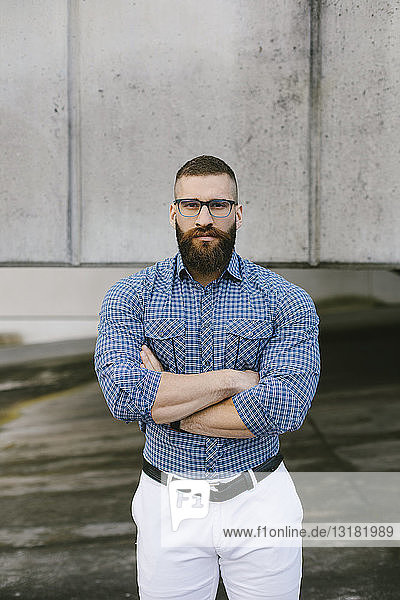 Portrait of bearded hipster businessman wearing glasses and plaid shirt