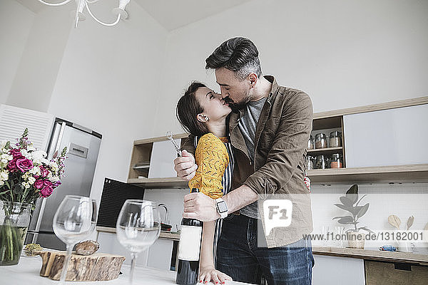 Couple in love kissing in the kitchen