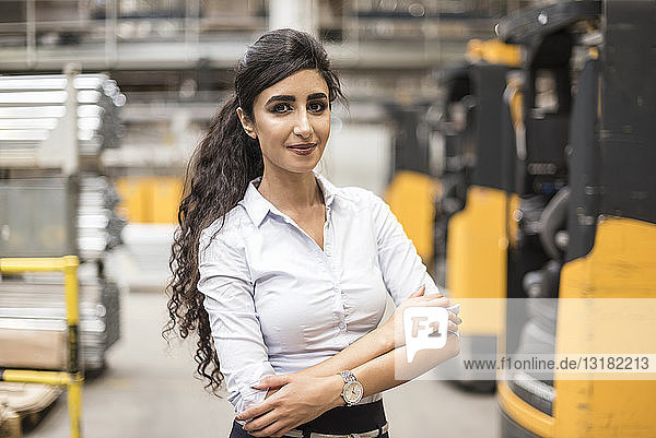 Portrait of confident woman in factory shop floor