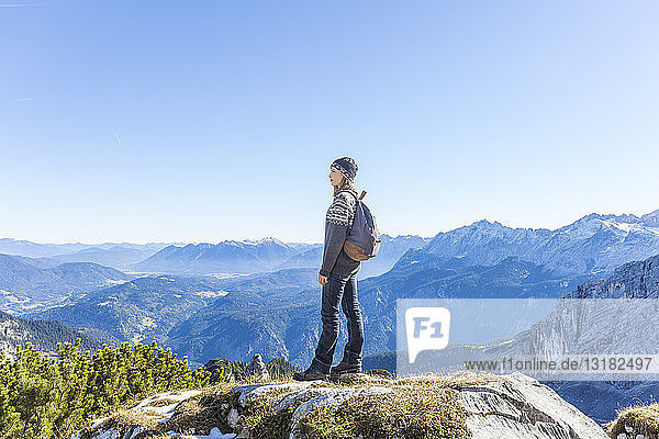 Germany  Garmisch-Partenkirchen  Alpspitze  Osterfelderkopf  female hiker on viewpoint looking at view