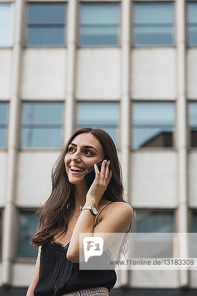 Portrait of smiling young woman on the phone