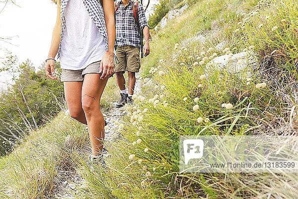 Italy  Massa  legs of young couple hiking in the Alpi Apuane mountains