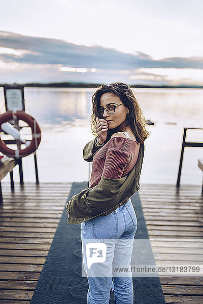 Pretty young woman posing on a pier at Lake Inari  Finland