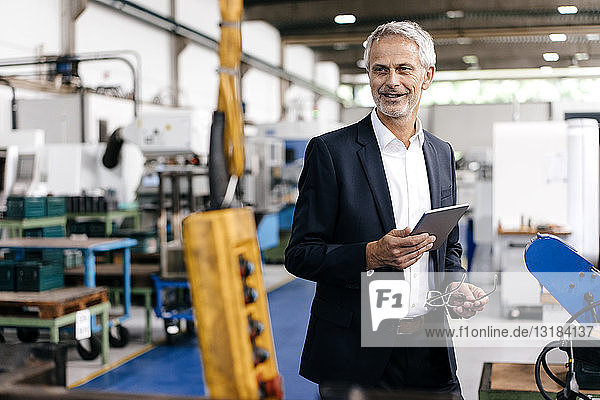 Manager using digital tablet in high tech company