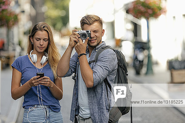 Netherlands  Maastricht  young couple exploring the city taking pictures