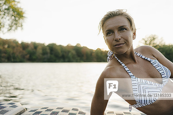 Portrait of woman wearing a bikini at a lake