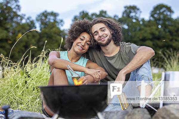 Happy couple having a barbecue in the nature