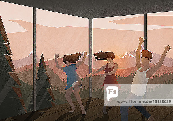Carefree friends dancing in house with sunset mountain view
