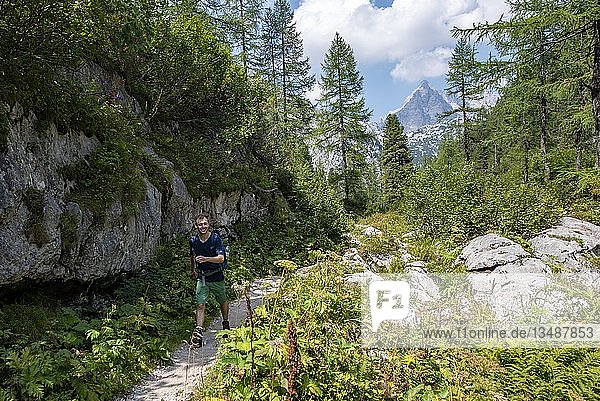 Hiker on hiking trail to KÃ¤rlingerhaus  behind Watzmann  KÃ¶nigssee  National Park Berchtesgaden  Berchtesgadener Land  Upper Bavaria  Bavaria  Germany  Europe