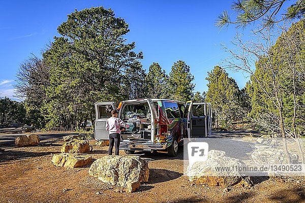 Junge Frau kocht am Gaskocher eines Campingwagens  Wohnmobils  Mather Campground  Grand Canyon National Park  South Rim  nahe Tusayan  Arizona  USA  Nordamerika
