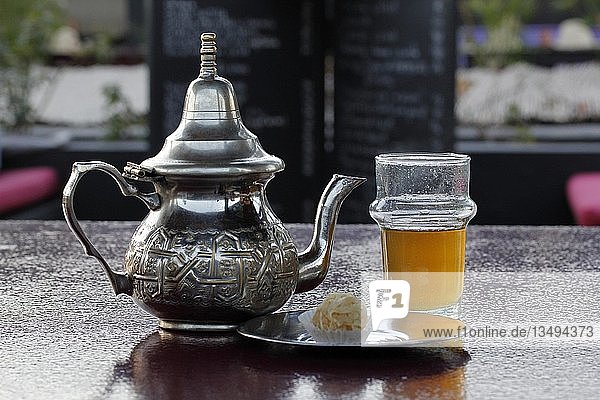 Moroccan silver teapot  glass of mint tea  Marrakesh  Morocco  Africa