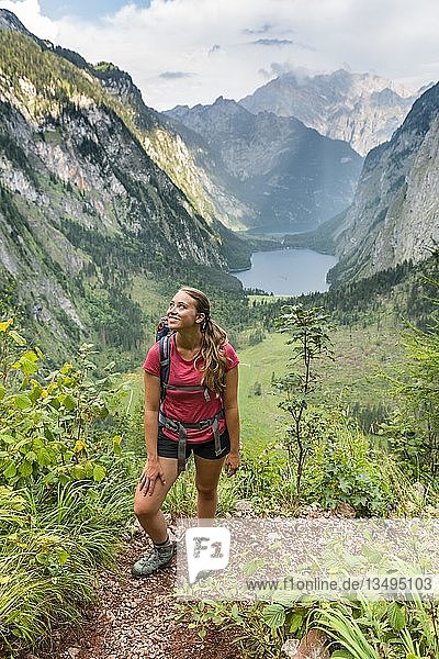 View of Obersee and KÃ¶nigssee  young hiker on the RÃ¶thsteig  behind Watzmann  Berchtesgaden  Upper Bavaria  Bavaria  Germany  Europe