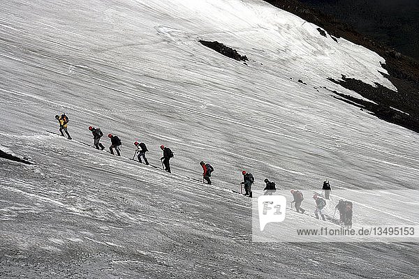 Mountain climbers climbing an ice field at the Villarrica or RucapillÃ¡n Volcano  Pucon  Chile  South America