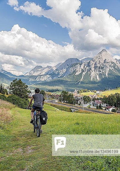 Cyclist on bike tour with mountain bike  on the cycle path Via Claudia Augusta  in the back Ehrwalder Sonnenspitze  crossing the Alps  mountain landscape  Alps  Ehrwald Basin  near Ehrwald  Tyrol  Austria  Europe