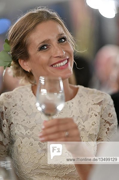 Bride with glass in her hand  cheers  Germany  Europe