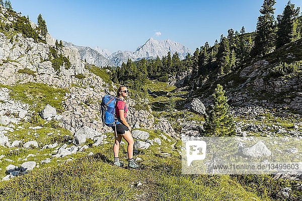 Hiker with rucksack  hiking trail in the Funtenseetauern  behind Watzmann  Berchtesgaden National Park  Berchtesgadener Land  Upper Bavaria  Bavaria  Germany  Europe