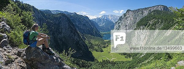 Blick auf den Obersee und Königsee  Wanderer sitzt auf Felsen am Röthsteig  hinter dem Watzmann  Berchtesgaden  Oberbayern  Bayern  Deutschland  Europa