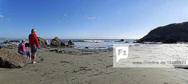 Two women on the sandy beach  Pacific Coast  Cambria  California  United States  North America