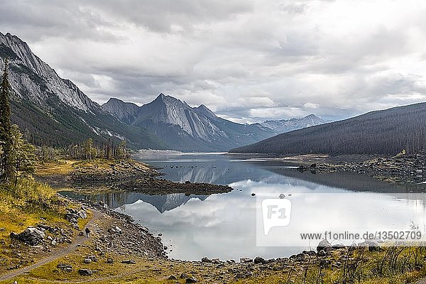 Mountains reflected in a lake  Medicine Lake  Maligne Valley  Jasper National Park  Alberta  Canada  North America