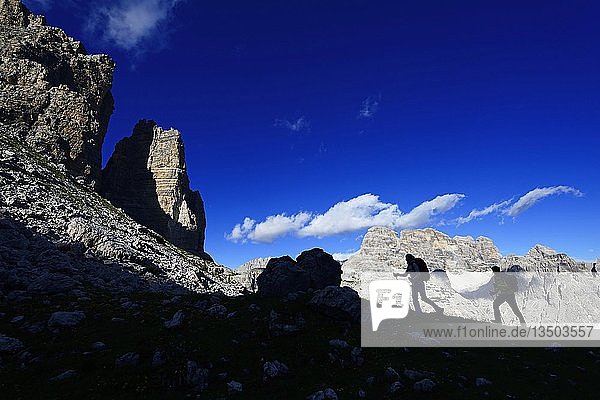 Silhouette  hikers on the hiking trail 101  behind the summit of the Einser  Sexten Dolomites  Alta Pusteria  South Tyrol  Italy  Europe