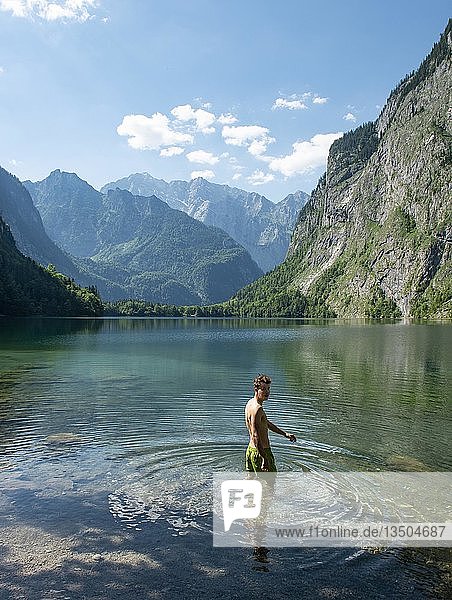 Young man bathes in lake Obersee  behind Watzmannmassiv  Salet am Königssee  Berchtesgaden National Park  Berchtesgadener Land  Upper Bavaria  Bavaria  Germany  Europe
