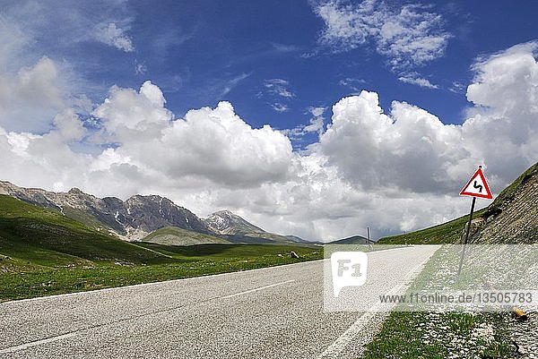 Traffic sign beside a street in the mountains under a blue sky  Gran Sasso in the Abruzzo region of Italy  Europe