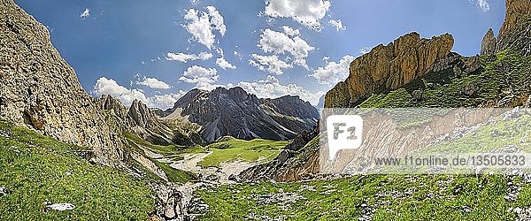Panoramic view of the Geisler Mountains  two hikers ascend to Mittagsscharte gorge  Puez-Geisler Nature Park  province of Bolzano-Bozen  Italy  Europe