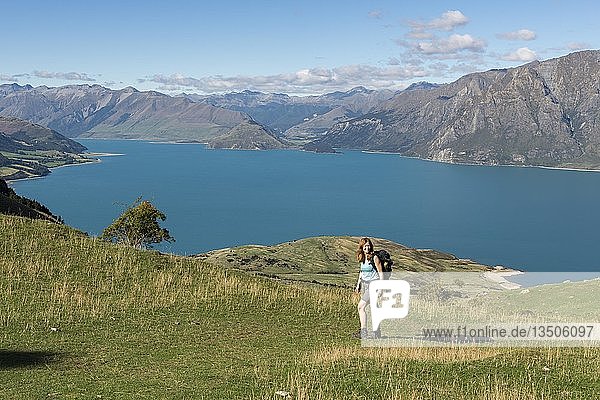 Female hiker at Isthmus Peak Track  Lake Hawea and mountain panorama  Otago  South Island  New Zealand  Oceania