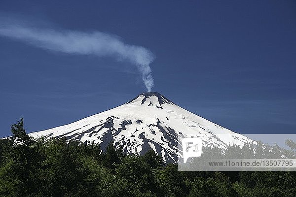 Volcanic smoke rising from Villarrica or RucapillÃ¡n Volcano  seen from Pucon  Chile  South America
