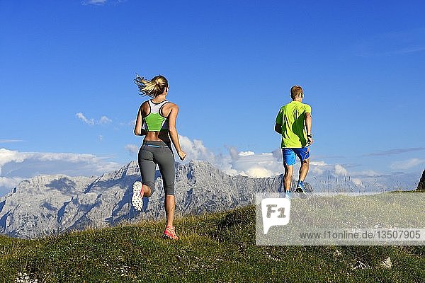 Hikers  Trail running on the Eggenalm  behind Loferer Steinberge  Reit im Winkl  Upper Bavaria  Bavaria  Germany  Europe