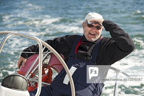 Skipper sitting at the stern of a yacht