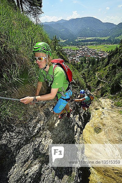 Climbers at rock face  via ferrata Hausbachfall  Reit im Winkl  Chiemgau  Bavaria  Germany  Europe