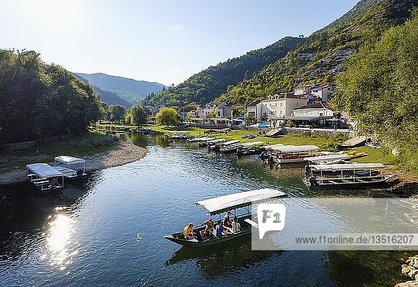 Boats on river Crnojevic Rijeka Crnojevica National Park Lake Skadar near Cetinje Montenegro Europe