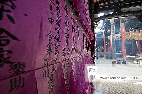 Prayer slip  black Chinese characters on pink tissue paper  in the temple Chua Thien Hau  Ho Chi Minh City  Saigon  Southeast Asia  Vietnam  Asia