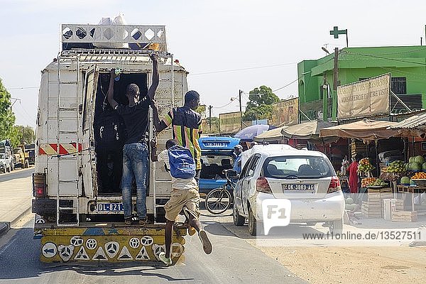 Man jumps on a bus  Dakar  Senegal  Africa