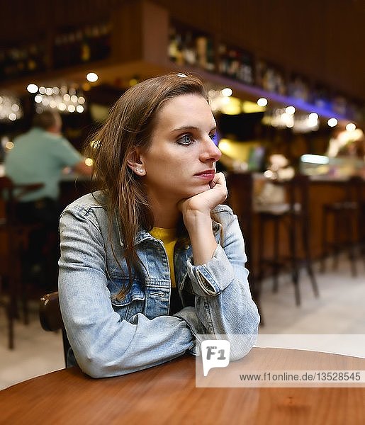 Young woman in a bar looks thoughtful  San Cristobal de La Laguna  Tenerife  Canary Islands  Spain  Europe