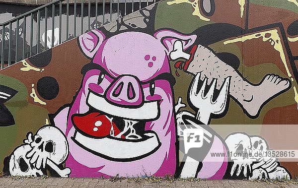Pig eats human flesh  graffiti  criticism of meat consumption  vegan life  Düsseldorf-Eller  North Rhine-Westphalia  Germany  Europe