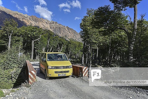 Yellow travel minibus on road to Lago del Desierto at Rio de las Vueltas near El Chalten Patagonia Argentina South America