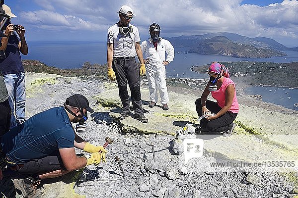 Volcanologists check sulfur fumaroles and chloride crusts on the crater rim  Gran Cratere  Vulcano Island  Aeolian Islands  Sicily  Italy  Europe