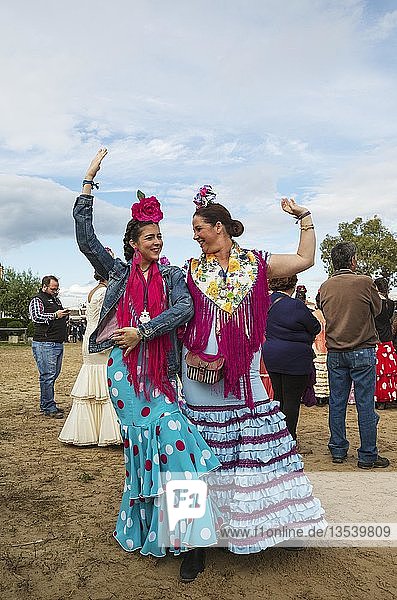 Women wearing colourful gypsy dresses dance the Sevillana  Pentecost pilgrimage of El Rocio  Huelva province  Andalusia  Spain  Europe