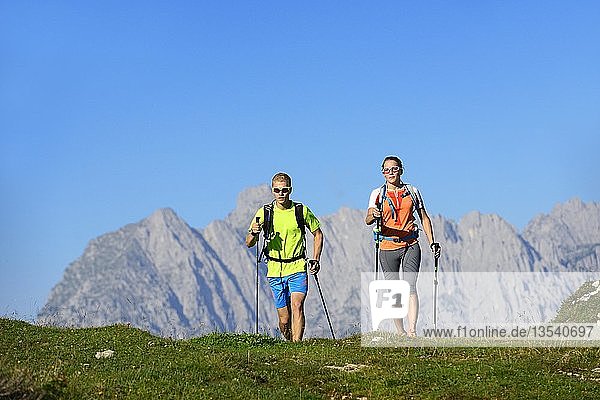 Hikers on the Eggenalm  behind Wilder Kaiser mountain range  Reit im Winkl  Upper Bavaria  Bavaria  Germany  Europe