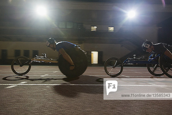 Paraplegic athlete speeding along sports track during wheelchair race