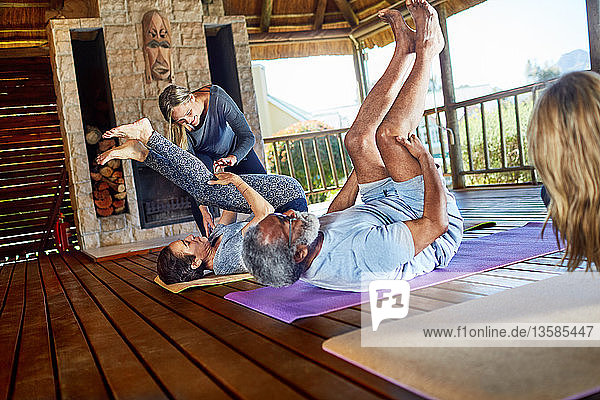 Yoga class stretching in hut during yoga retreat